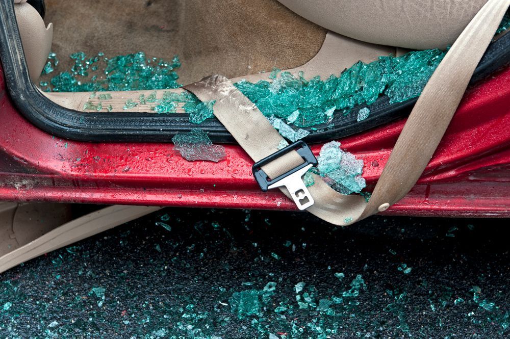 A car seat littered with broken glass